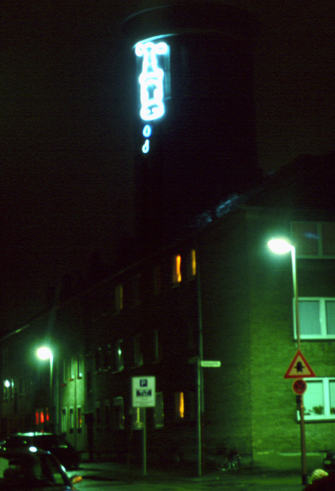 outdoor light installation on water tower above houses. scarcely dripping water only