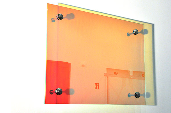 Site specific artwork. Wall hanging color changing glass panes. Installation University Rostock. YLS Yvonne Lee Schultz