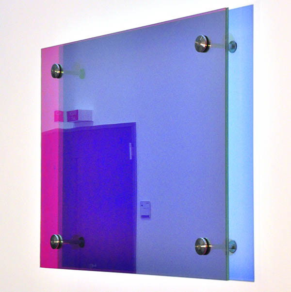 Site specific artwork. Wall hanging color changing glass panes. Installation University Rostock. YLS Yvonne Lee Schultz