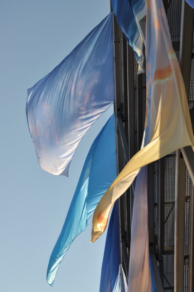 ONE SKY FLAGS are flags showing photos of the sky above Germany. Site specific artwork installation in Berlin. With participation of teenagers in Germany. By YLS Yvonne Lee Schultz