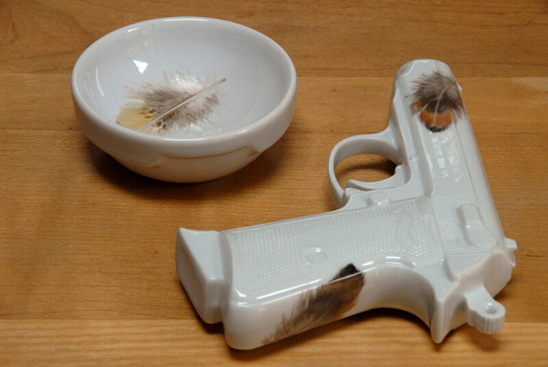 Feathers on porcelain gun. Unique art object by artist YLS Yvonne Lee Schultz. Extraordinary present for Thanksgiving or classy gift for deer hunter. Comes with bowl. Exclusive offer, one off.