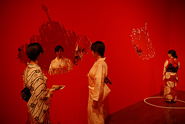 Wall hanging artwork. Mirrors present flat sparkling silhouettes of luxurious chandeliers. They beautifully reflect visitors in Kimonos in the art exhibition at Contemporary Art Museum Kumamoto. By YLS Yvonne Lee Schultz