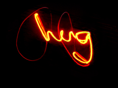 Small wall hanging art light gives warm light on sad days: neon handwriting "hug" by YLS Yvonne Lee Schultz