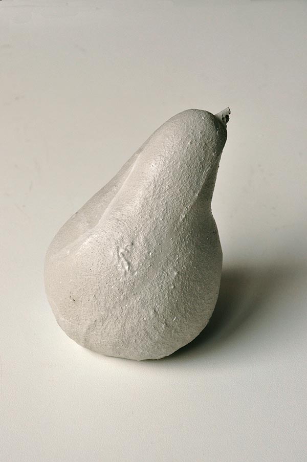 Pear covered in concrete. Still life series. Photography of ephemeral artwork by Yvonne Lee Schultz